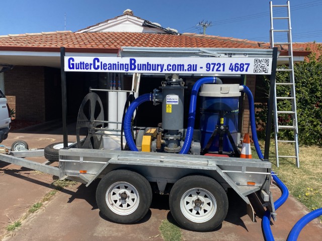 Trailer-mounted vacuum unit for high-reach gutter cleaning